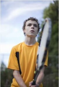 boy playing tennis