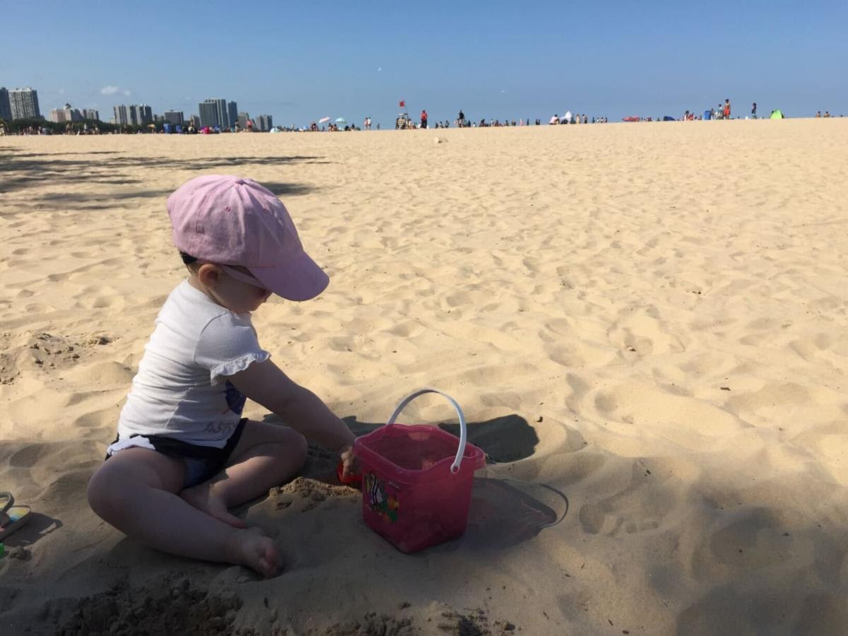 child plays in the sand