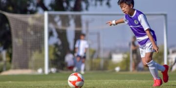 boy playing soccer
