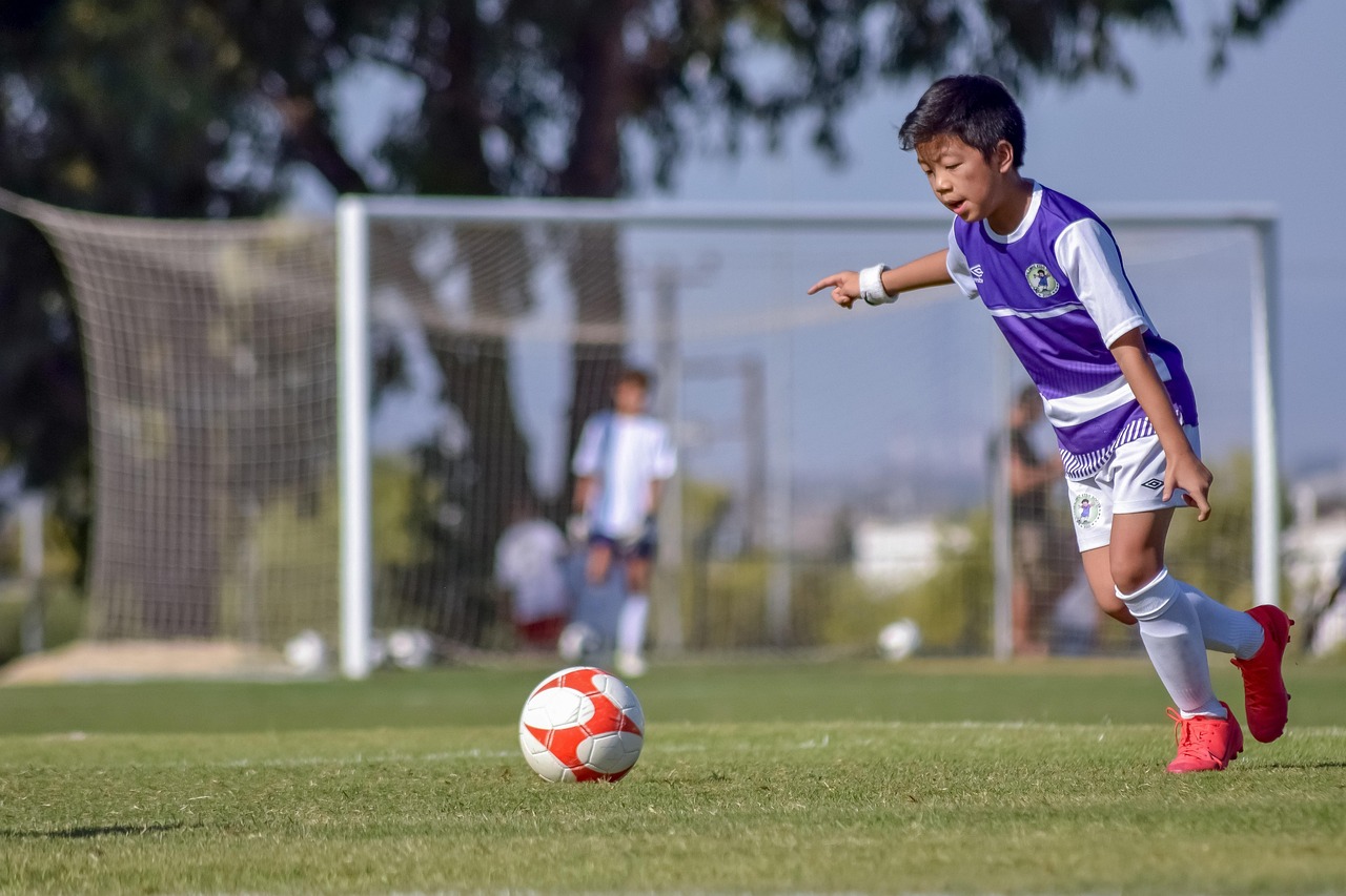 boy playing soccer